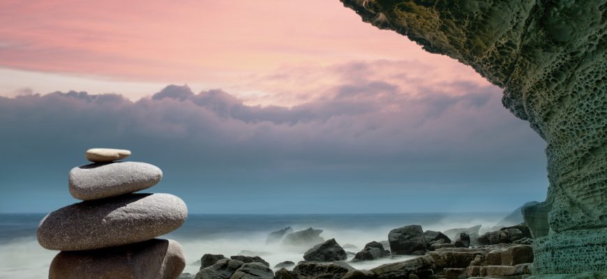 Zen rocks set against a calming sky and sea