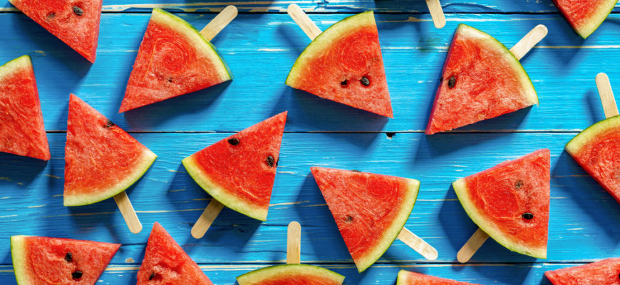 watermelon popsicles over a blue background