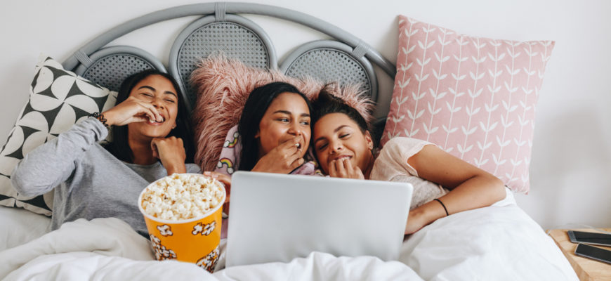 Girls,Having,A,Sleepover,Enjoying,A,Movie,On,Laptop,With