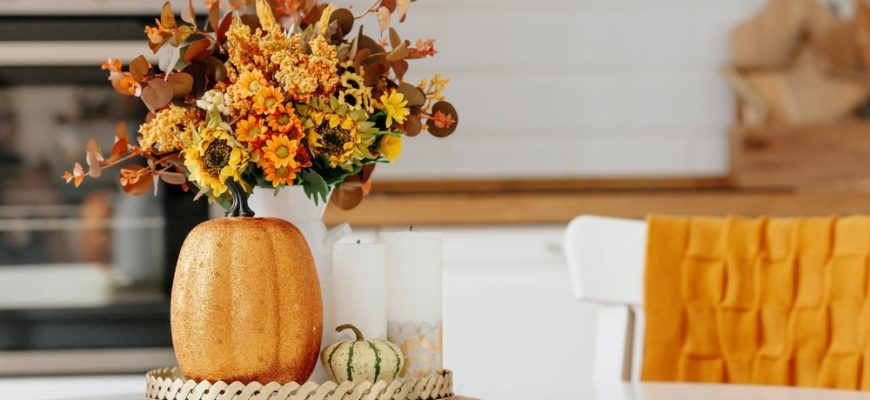 Still-life.,Yellow,,Orange,Flowers,In,A,Vase,,Pumpkins,And,Candles