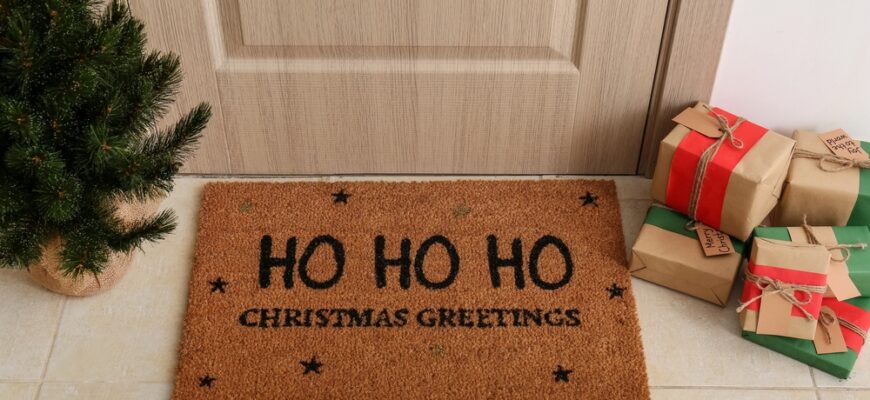 Mat,With,Christmas,Greeting,,Gifts,And,Small,Fir,Tree,Near