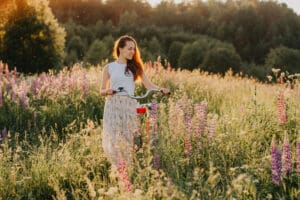 Young,Woman,With,Bicycle,In,The,Park