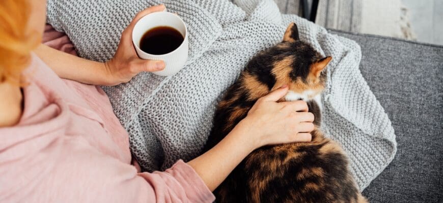 Close-up,Woman,In,A,Plaid,Drinking,Hot,Tea,,Petting,A
